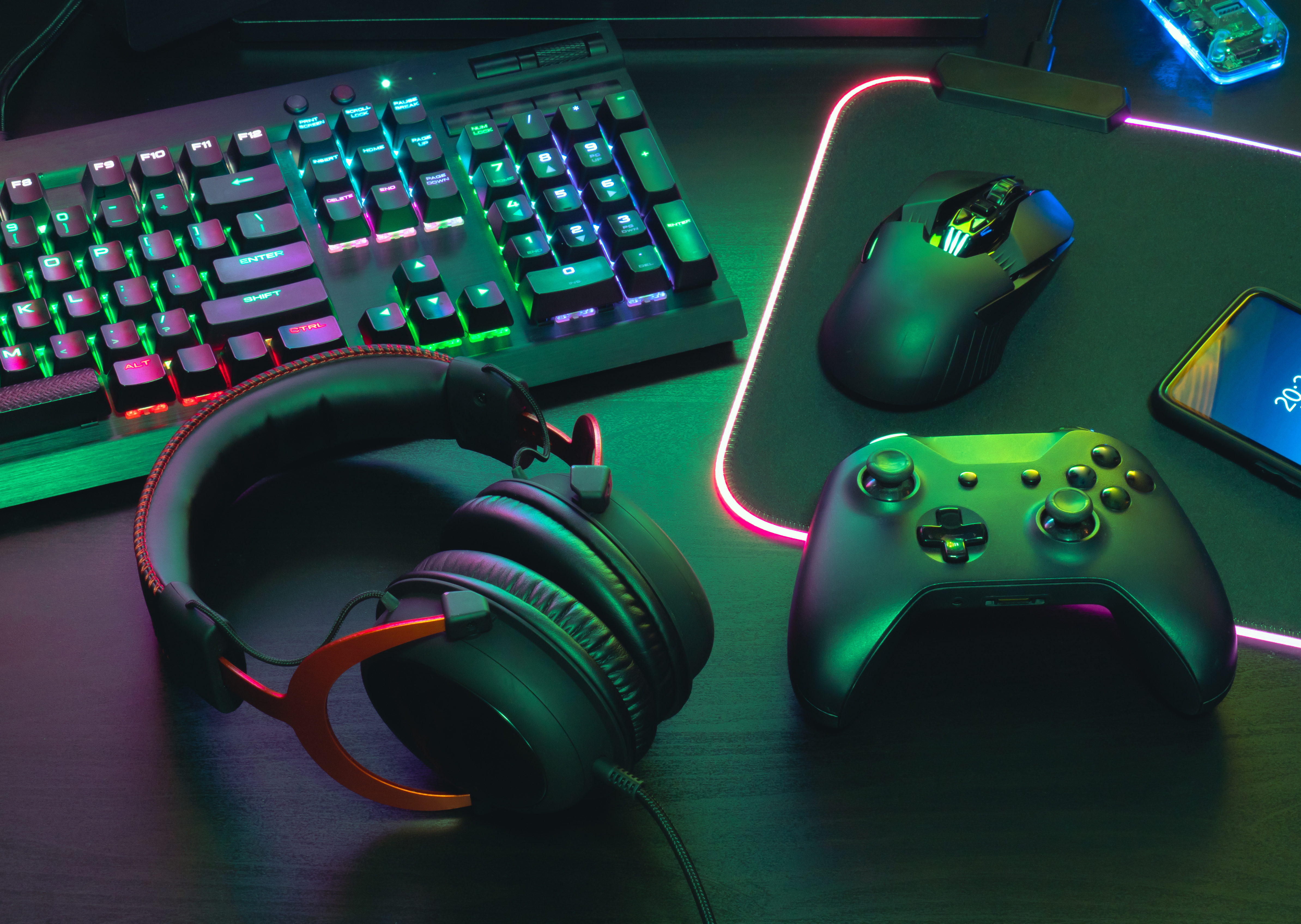 A keyboard, mouse, game controller, and headset with LED lights