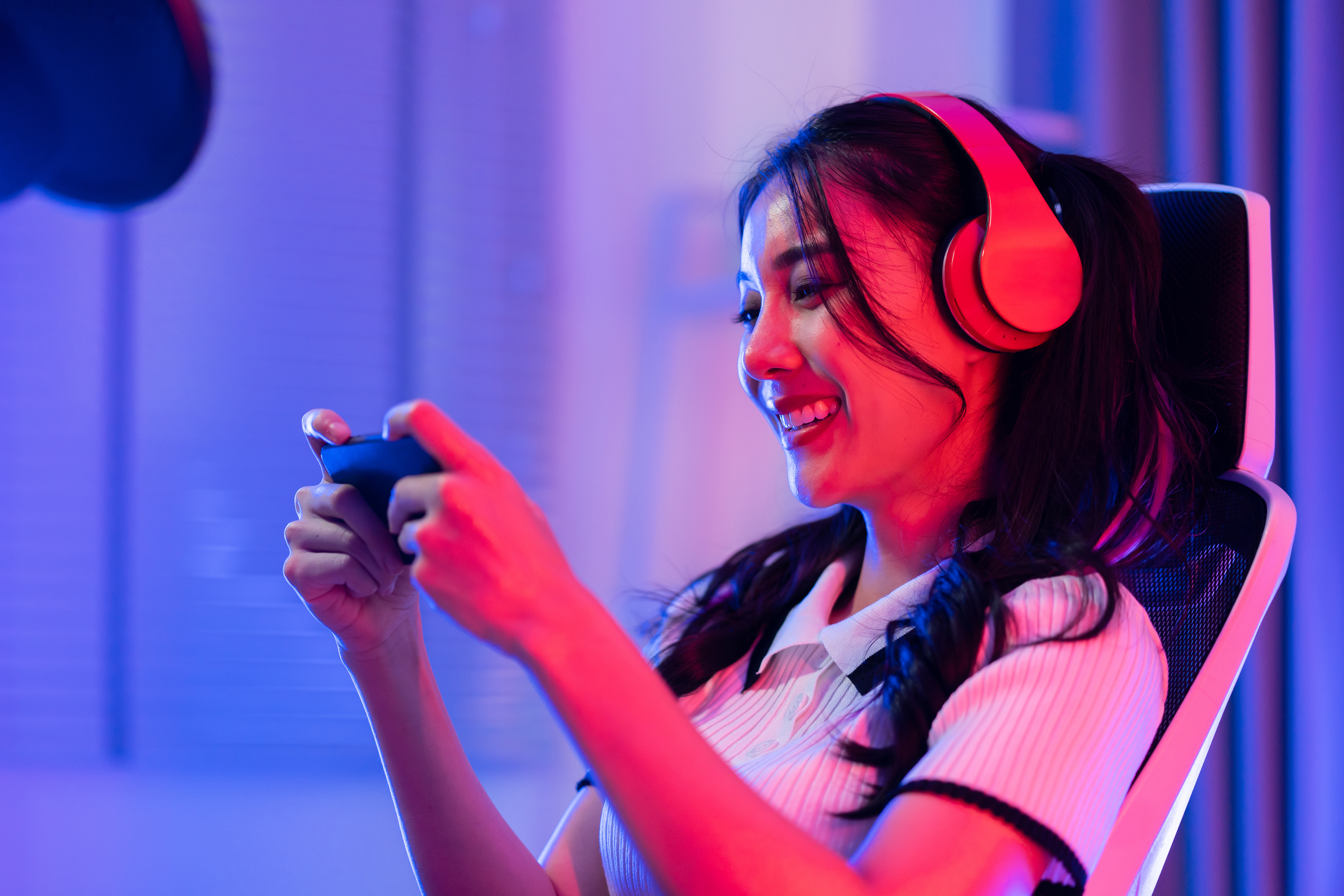 Woman playing mobile game with headset on