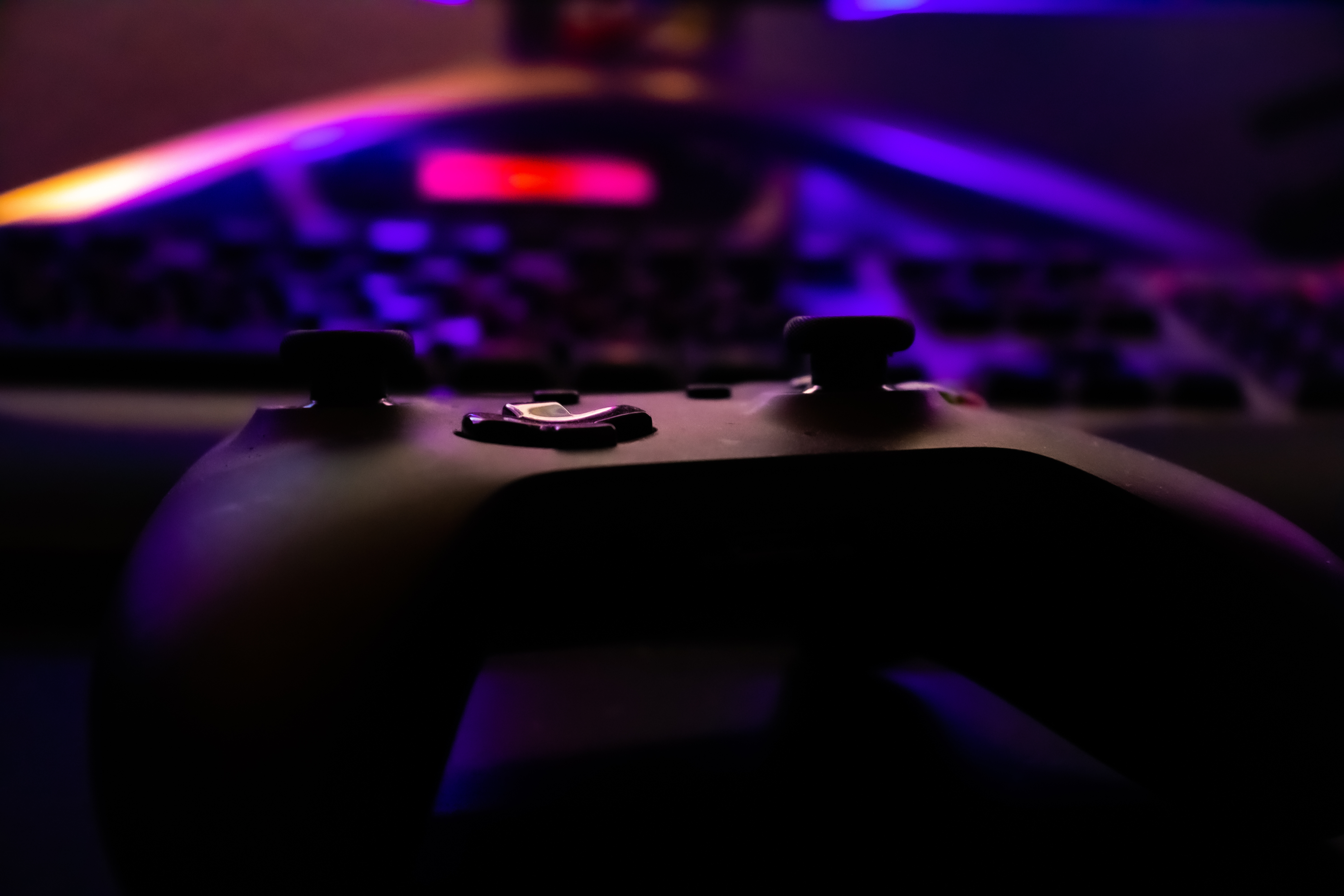 An XBOX controller lying on someone's gaming desk.