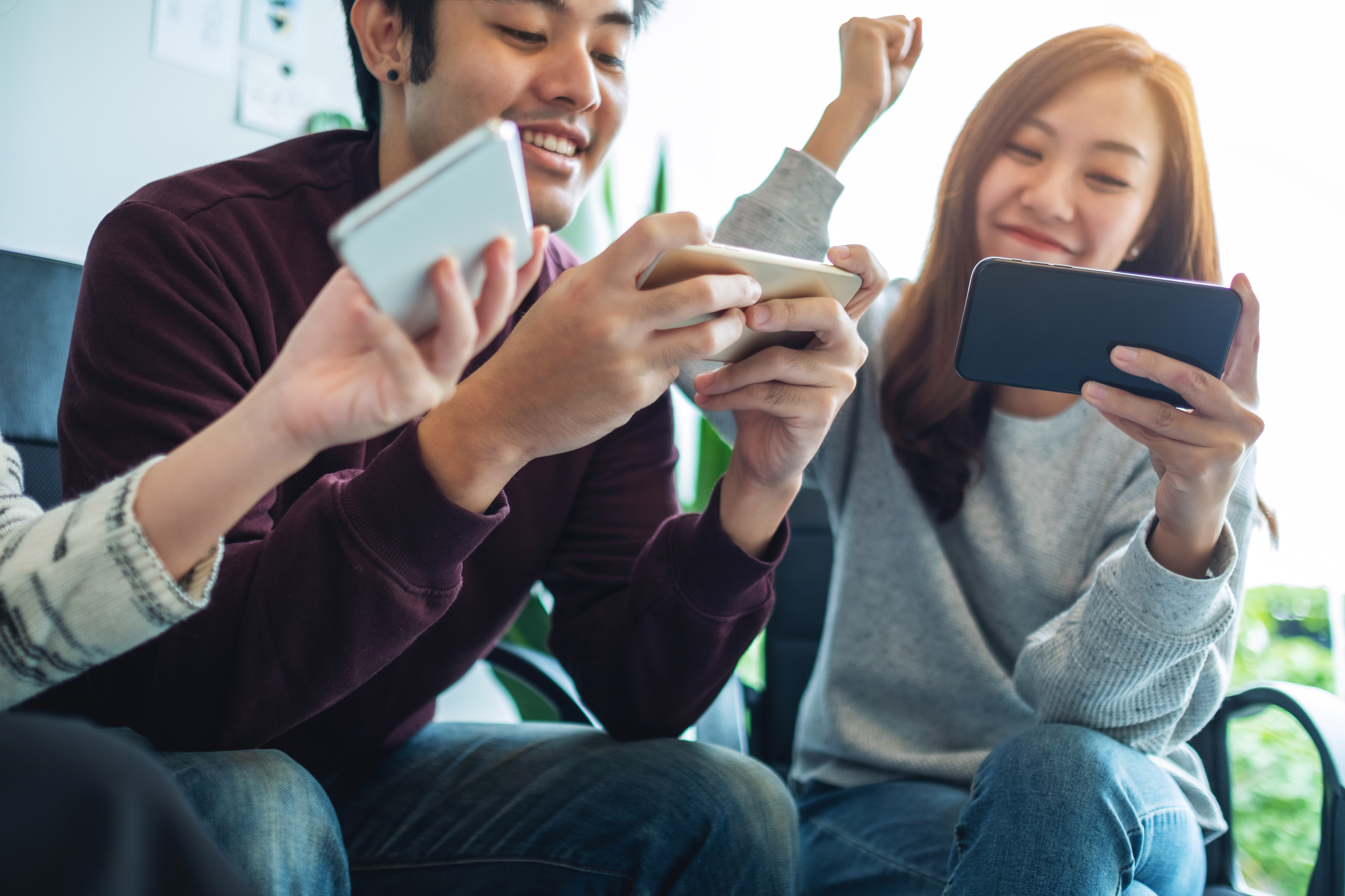 Some friends gaming together on their smartphones.